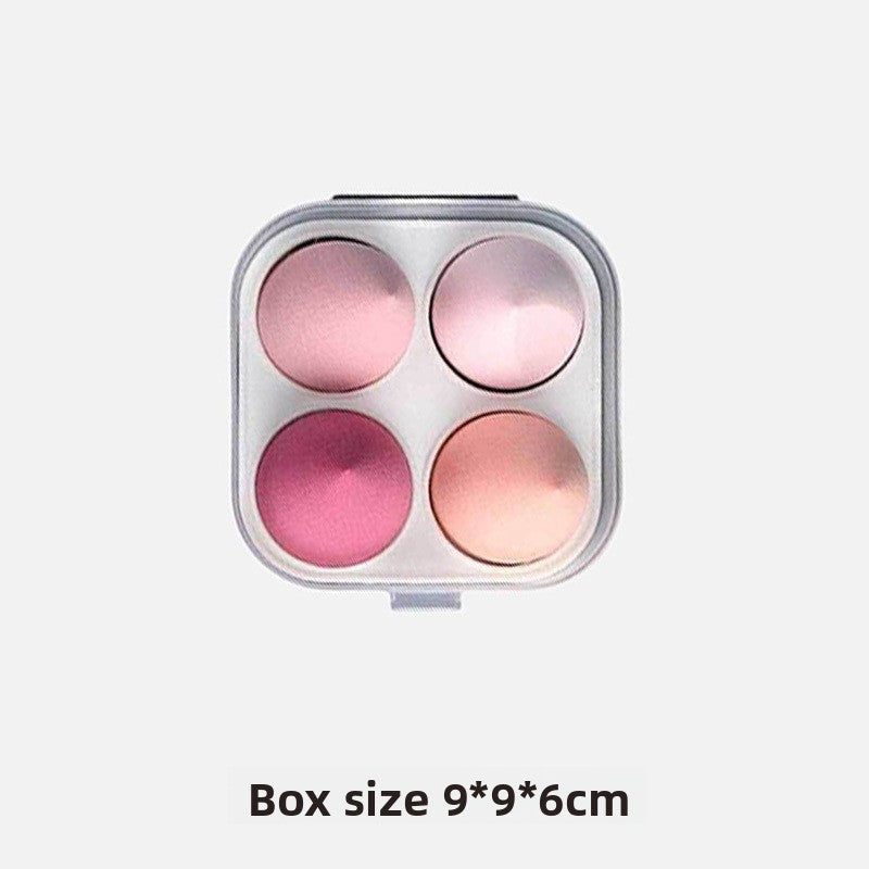 Makeup palette with four pink shades in a compact case on a white background